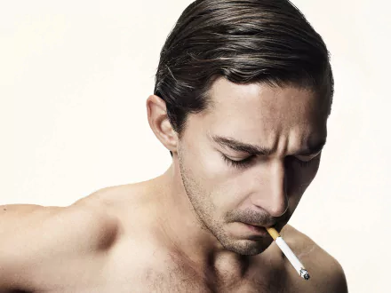 HD desktop wallpaper featuring a contemplative person with slicked-back hair lighting a cigarette.