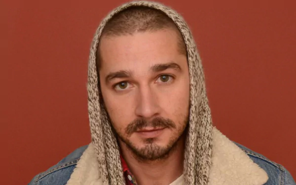 HD wallpaper of a person with a hoodie in a denim jacket against a maroon background, serving as a desktop backdrop.