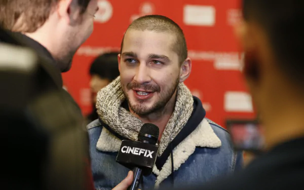 Shia LaBeouf smiling during an interview, suitable as a high-definition desktop wallpaper.