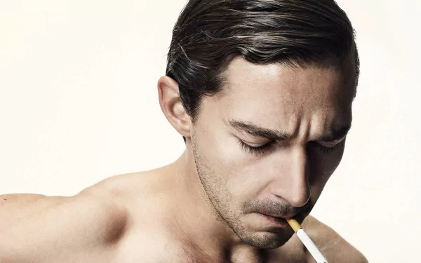 HD desktop wallpaper featuring a contemplative person with slicked-back hair lighting a cigarette.