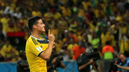 HD desktop wallpaper featuring a football player in a yellow kit celebrating with a crowd in the background.