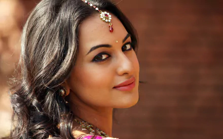 A close-up of Indian celebrity Sonakshi Sinha, showcasing her elegant features and long, flowing hair, adorned with traditional jewelry. This HD image serves as a stunning desktop wallpaper.