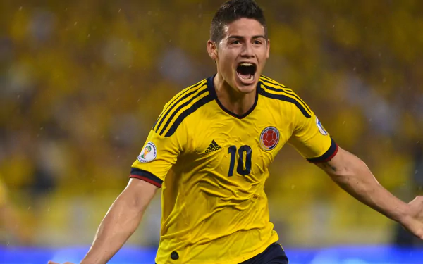 HD wallpaper of a thrilled soccer player in Colombia's yellow jersey, number 10, with a celebratory expression during a match.