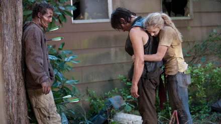 HD PC desktop wallpaper featuring a dramatic scene from The Walking Dead TV show with characters facing a zombie outside a house.