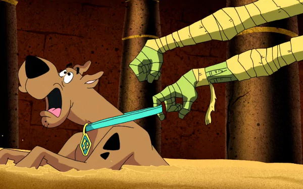 HD PC desktop wallpaper from the video game Scooby-Doo!: Mystery Mayhem — Scooby recoils in sand as wrapped green monster arms grab his collar and aim a dagger.