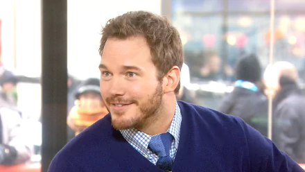 HD wallpaper featuring a smiling person in a blue sweater, suitable as a desktop background.