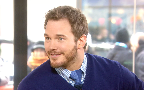 HD wallpaper featuring a smiling person in a blue sweater, suitable as a desktop background.