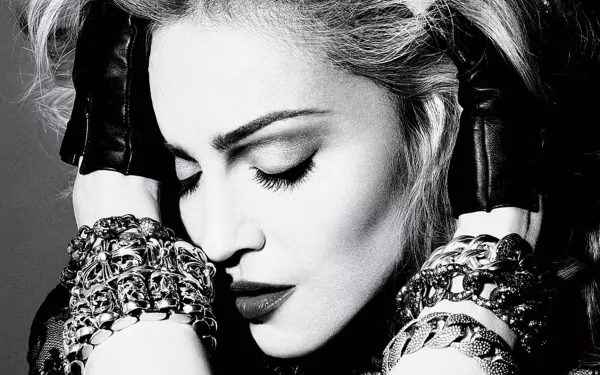 Black-and-white HD PC desktop wallpaper of a female musician with headphones, closed eyes, leather gloves and layered bracelets — moody glamorous close-up.