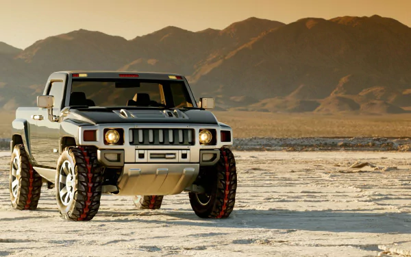 HD desktop wallpaper featuring a Hummer H3T Concept vehicle parked on a dry, cracked desert landscape with mountains in the background.