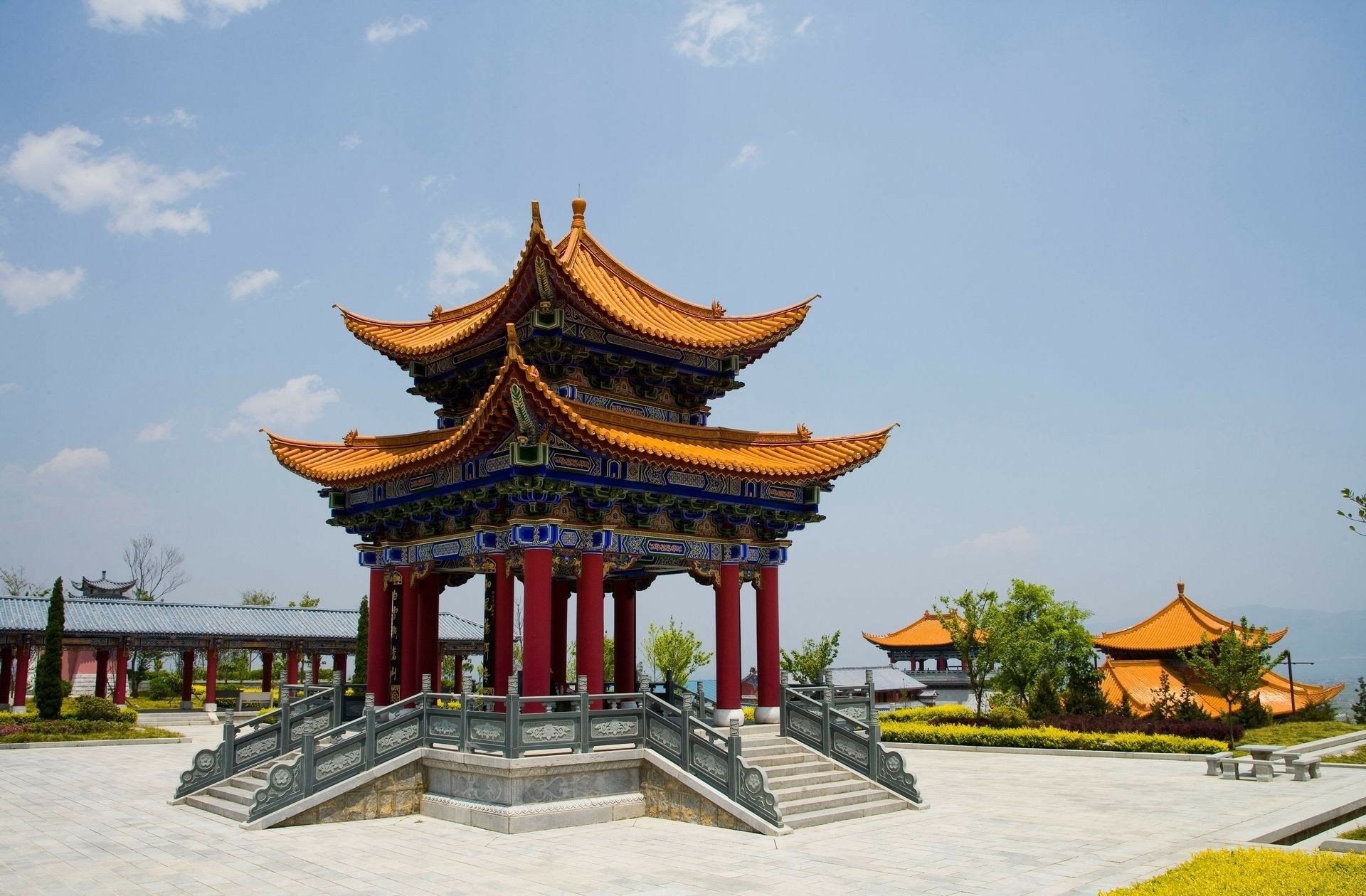 HD desktop wallpaper featuring a vibrant religious chapel with traditional temple architecture under a clear blue sky.