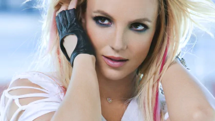 HD PC desktop wallpaper featuring a close-up of Britney Spears with bold makeup and edgy style, capturing her iconic music persona.