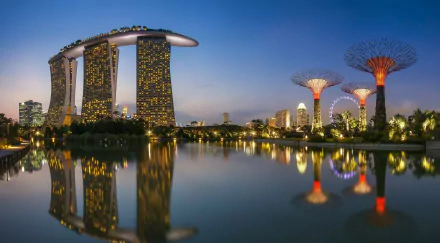 HD PC desktop wallpaper of Marina Bay Sands in Singapore at dusk — man-made skyline and illuminated Supertrees mirrored in calm bay waters.