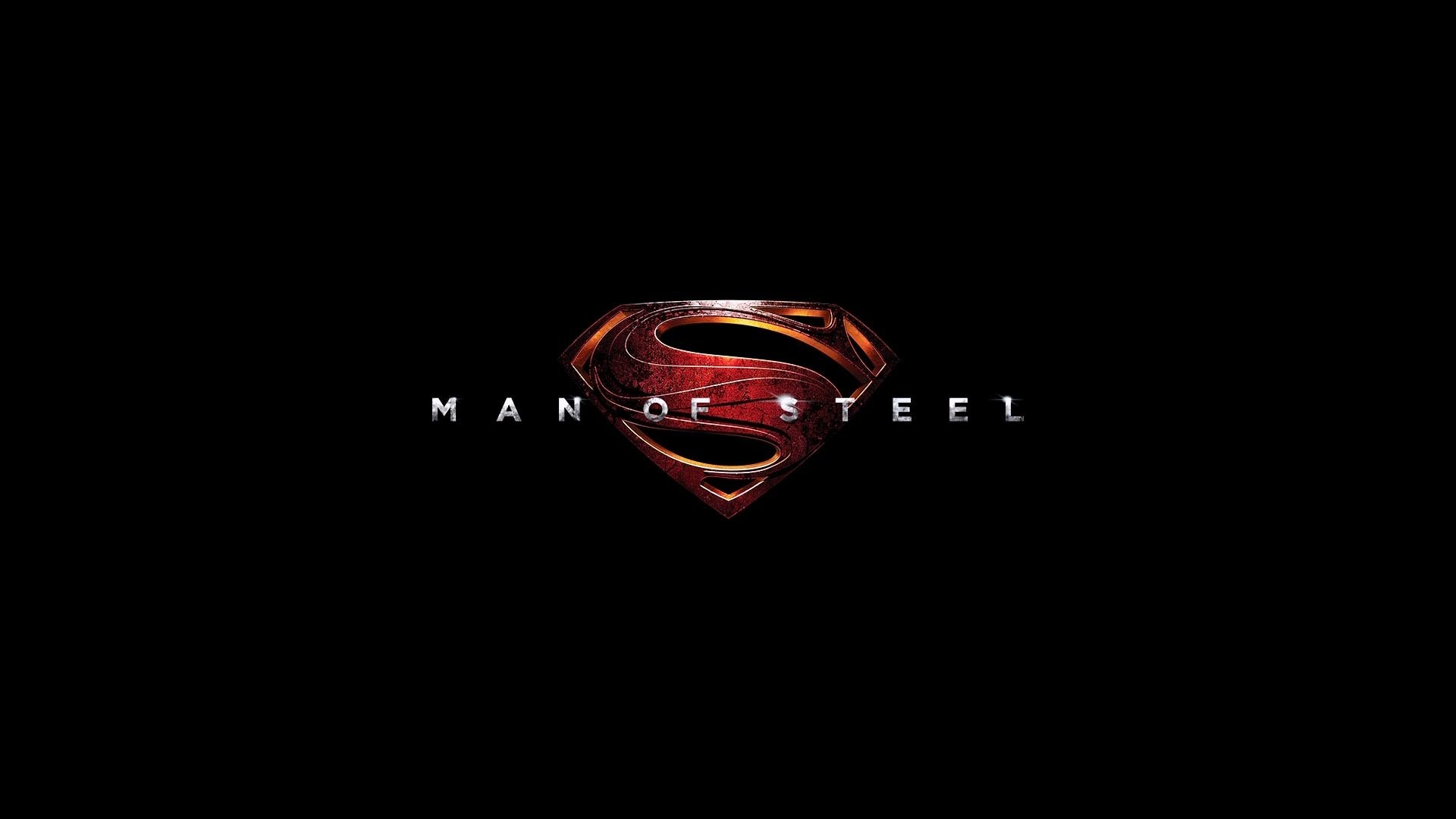 HD PC desktop wallpaper featuring the Man of Steel movie's metallic Superman logo glowing red and gold against a deep black background.