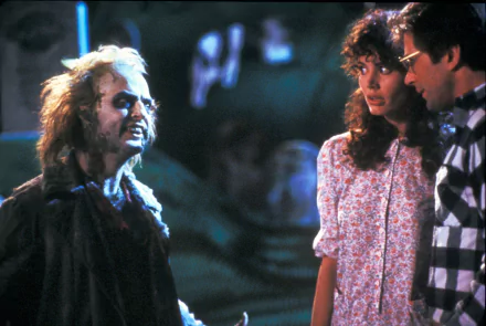 HD PC desktop wallpaper featuring a scene from the movie Beetlejuice with Beetlejuice confronting two characters in a dark, eerie setting.