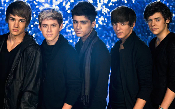 A vibrant HD wallpaper featuring One Direction, showcasing the five members standing confidently against a sparkling blue backdrop, embodying the energy of their music.