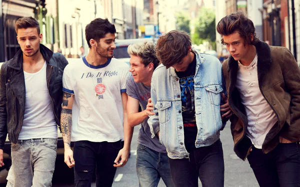 A vibrant HD wallpaper featuring One Direction walking down a lively street, showcasing their camaraderie and youthful energy in a music-themed setting.
