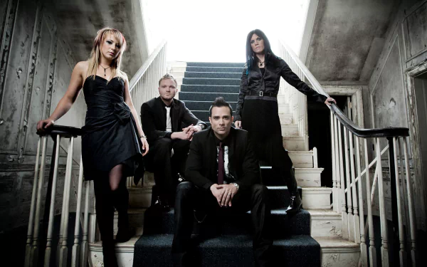 HD PC desktop wallpaper featuring the rock band Skillet posing on a stairway in a dim, industrial setting.