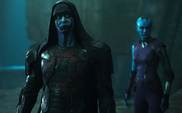Ronan the Accuser stands menacingly in dark armor, with Nebula in the background, in a cinematic scene from Marvel's Guardians of the Galaxy. 4K Ultra HD desktop wallpaper.