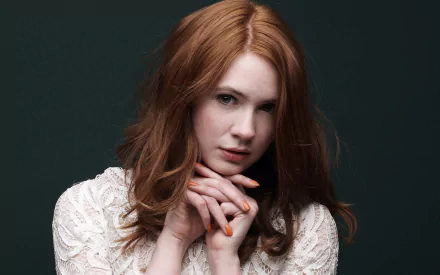 HD desktop wallpaper featuring Scottish actress Karen Gillan with red hair and a white lace top against a dark background.