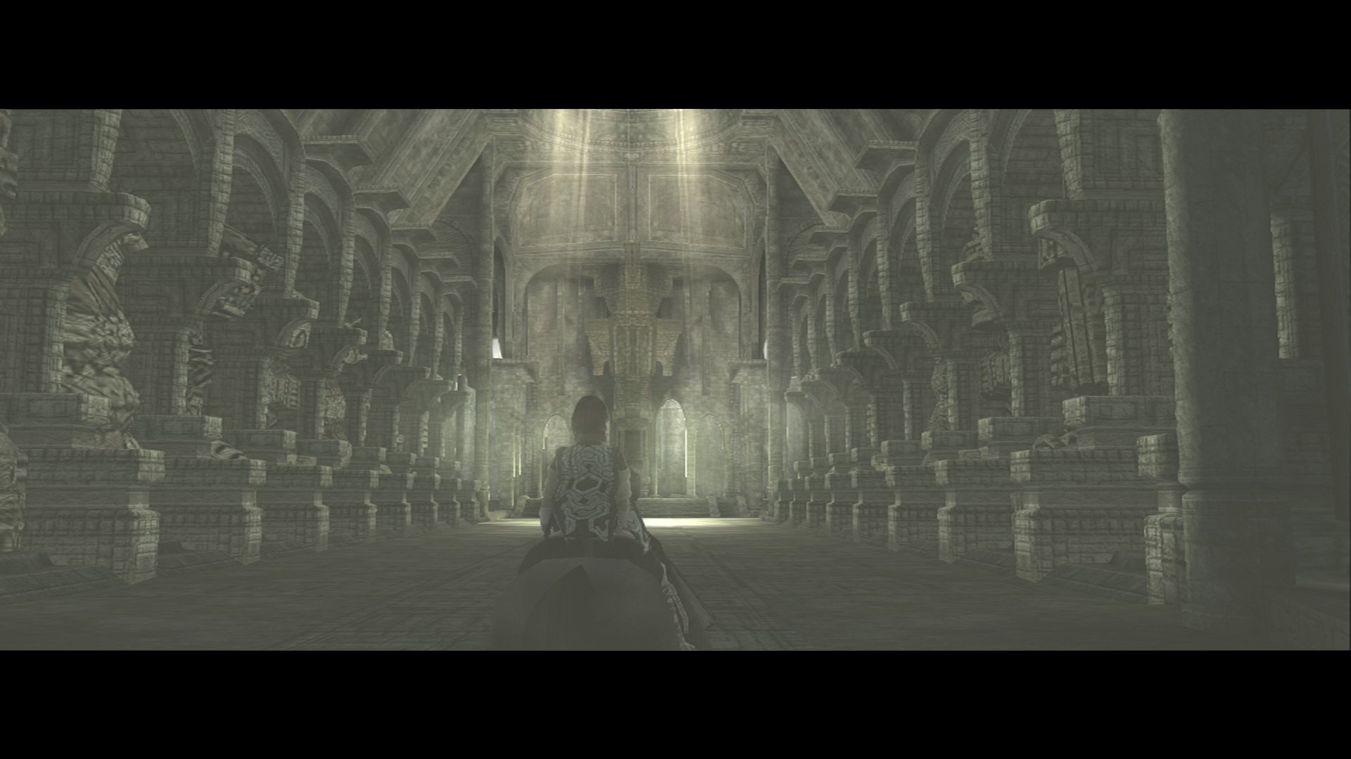 HD PC desktop wallpaper depicting a grand, ancient hall from the video game Shadow of the Colossus, featuring intricate stone pillars and a lone figure bathed in soft light.