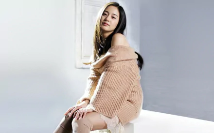 A serene portrait of Kim Tae-hee, the renowned Korean actress, showcasing her beauty in a cozy, off-shoulder sweater. This high-definition image serves as a stylish desktop wallpaper.
