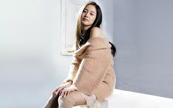 A serene portrait of Kim Tae-hee, the renowned Korean actress, showcasing her beauty in a cozy, off-shoulder sweater. This high-definition image serves as a stylish desktop wallpaper.