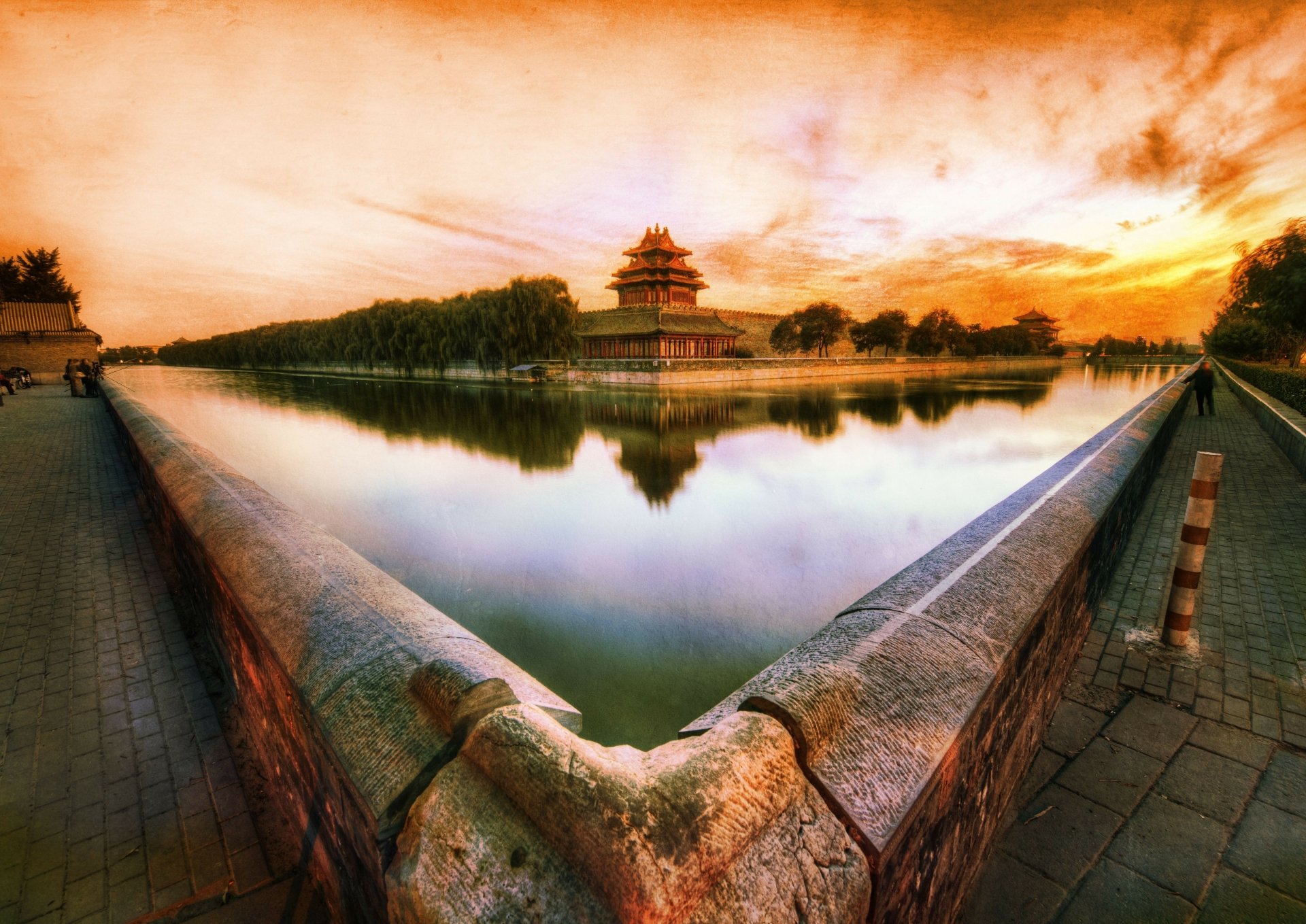 4K Ultra HD image featuring the man-made Forbidden City in Beijing, China, with its historic architecture reflected in the calm water under a vibrant sunset sky.