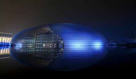 Blue-lit Beijing National Grand Theatre, egg-shaped modern theater reflected on water at night — 4K Ultra HD PC desktop wallpaper, Beijing, China.
