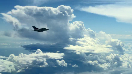 HD desktop wallpaper featuring a military Panavia Tornado jet fighter soaring through a vibrant sky filled with dramatic clouds.