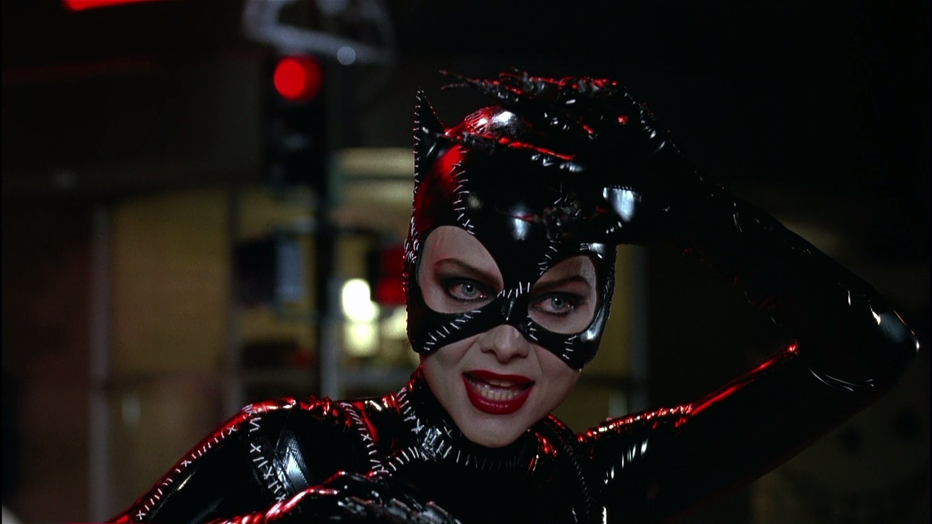 HD PC desktop wallpaper from the movie Batman Returns featuring Catwoman in her iconic black latex costume against a dark urban backdrop.