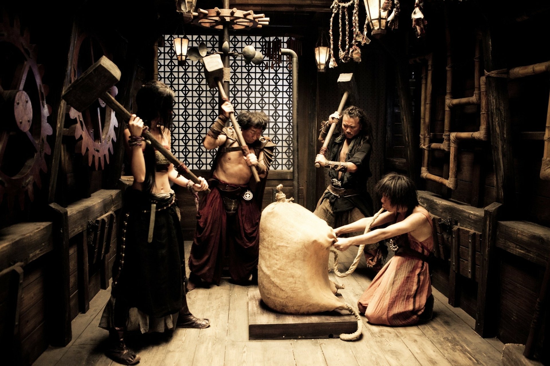 A dynamic scene from the movie Journey To The West, featuring characters in a rustic setting, working with tools, set against a backdrop of intriguing decor. HD desktop wallpaper.