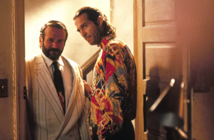 HD wallpaper featuring a scene from The Fisher King with a character portrayed by Robin Williams standing next to another character.
