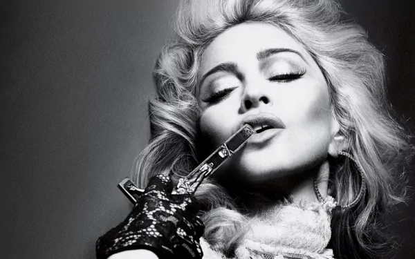 Black and white HD desktop wallpaper of Madonna, capturing her iconic style with dramatic lighting and a vintage, glamorous look in a music-themed portrait.