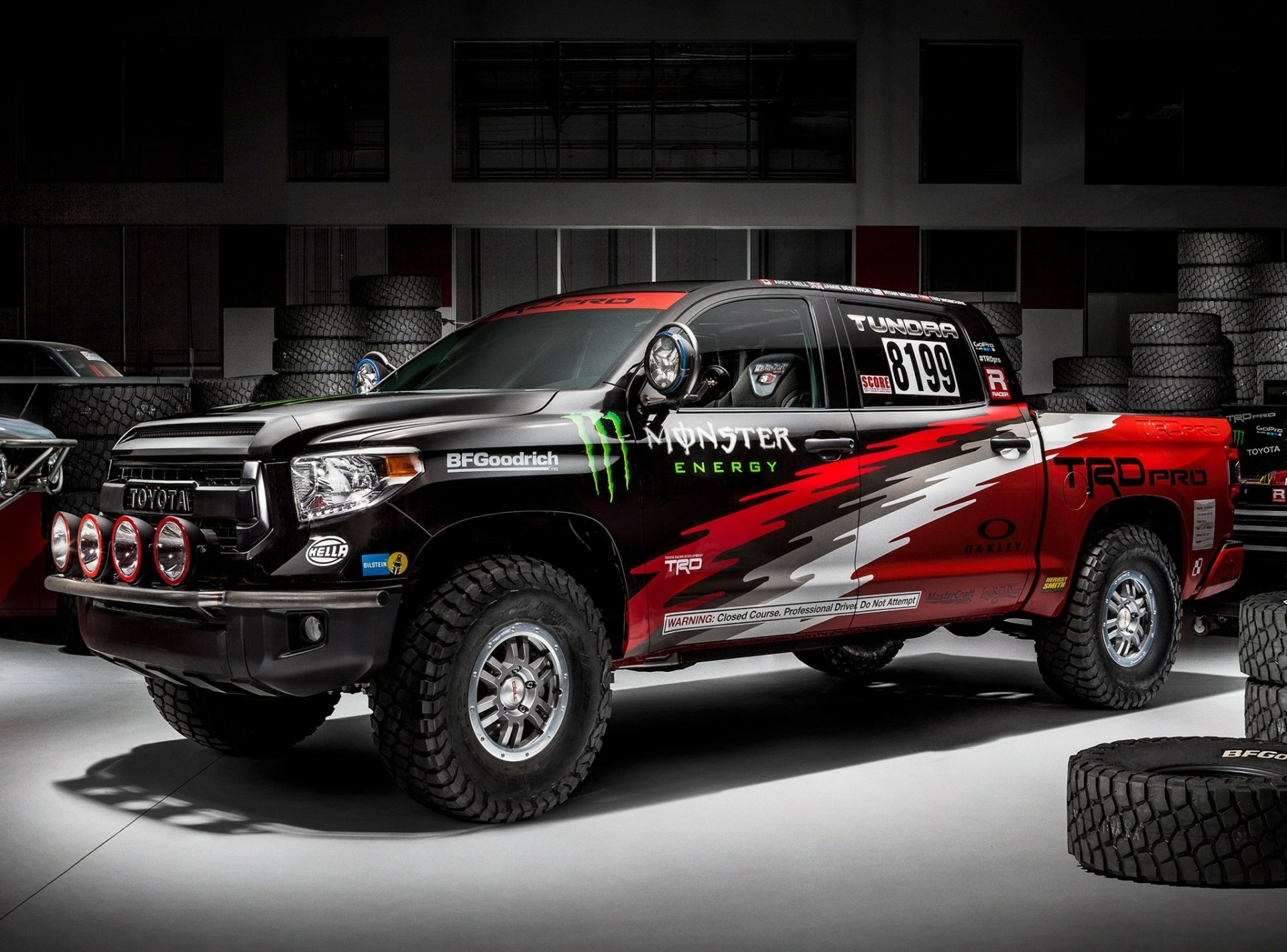 HD PC desktop wallpaper featuring a Toyota Tundra vehicle with Monster Energy and TRD Pro branding in a garage setting.