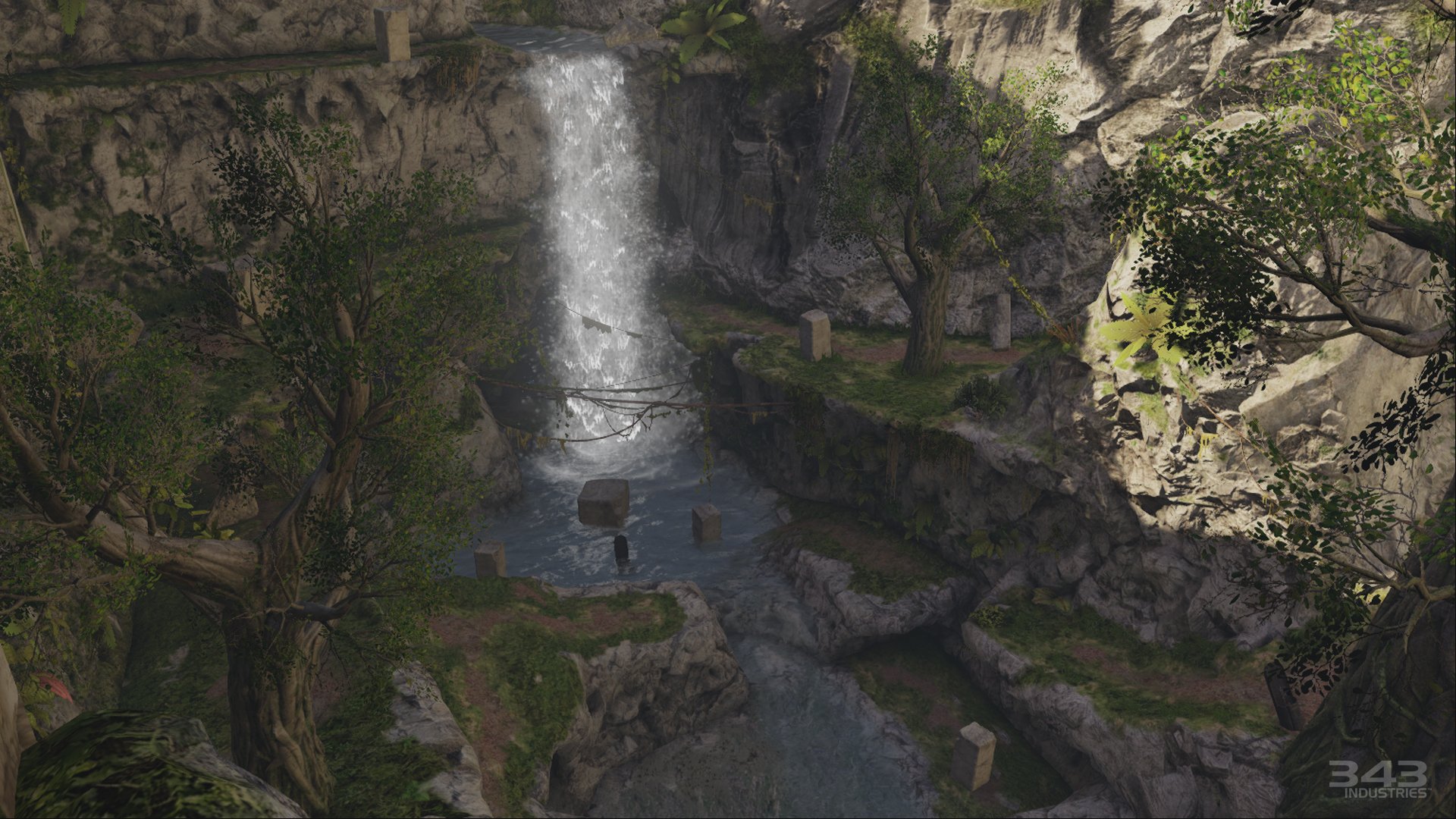HD PC desktop wallpaper from the video game Halo: The Master Chief Collection depicting a sunlit canyon with a cascading waterfall into a pool, overgrown ruins and rocky cliffs framed by trees.