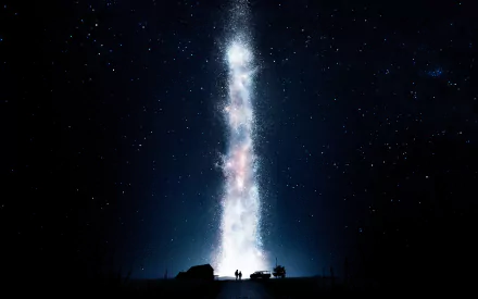 HD desktop wallpaper depicting a scene from the movie Interstellar, featuring a luminous, star-filled night sky with a silhouette of two figures standing by a car.