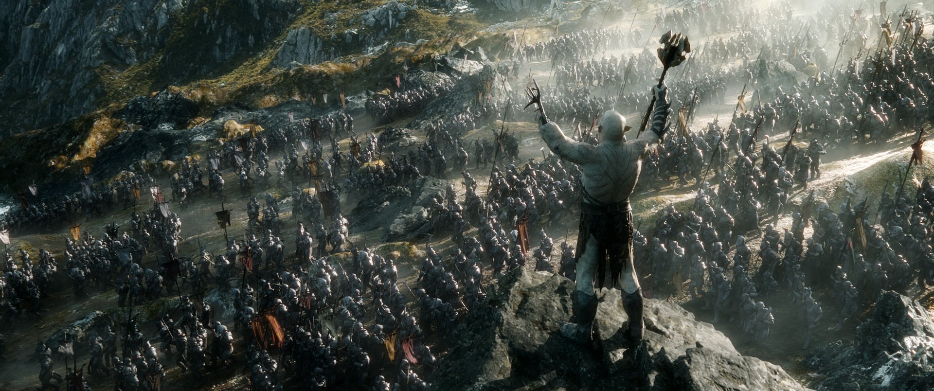 HD PC desktop wallpaper from the movie The Hobbit: The Battle of the Five Armies, showcasing a massive battlefield with a towering figure overlooking the army.