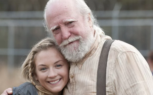 A heartwarming moment between two characters from the TV show The Walking Dead, set against a blurred background, making it a striking HD desktop wallpaper.