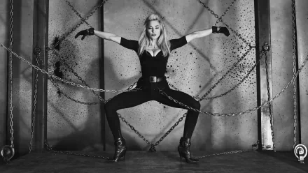 Black and white HD desktop wallpaper featuring Madonna in a striking pose with chains, embodying a bold, edgy music-inspired aesthetic.