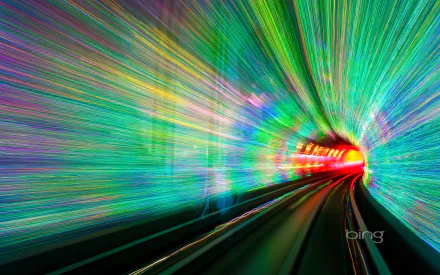 Colorful motion blur effect inside the man-made Bund Sightseeing Tunnel in China, featuring vibrant hues along a railroad track, captured in HD for a dynamic desktop wallpaper background.