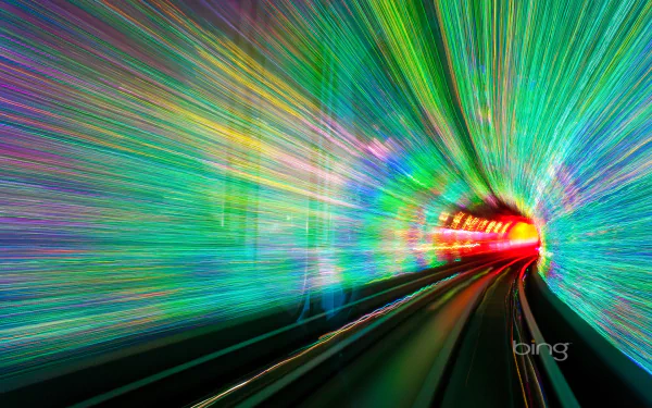 Colorful motion blur effect inside the man-made Bund Sightseeing Tunnel in China, featuring vibrant hues along a railroad track, captured in HD for a dynamic desktop wallpaper background.