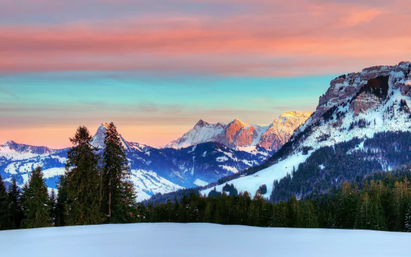 A breathtaking winter scene of the Swiss Alps, featuring majestic snow-covered mountains under a colorful sky, surrounded by evergreen trees, showcasing the beauty of nature.