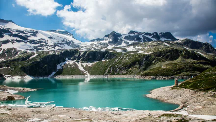 A stunning view of the Alps featuring a turquoise lake surrounded by majestic snow-capped mountains, captured in vibrant detail for a 4K Ultra HD desktop wallpaper.
