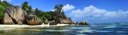HD PC desktop wallpaper: tropical nature scene with turquoise sea, white-sand beach and granite boulders beneath a bright blue sky in the tropics.