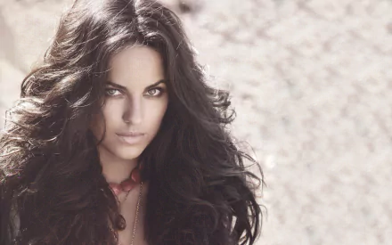 A striking image of Mexican actress Bárbara Mori, featuring her with long, flowing hair and an intense gaze, serves as a captivating HD desktop wallpaper and background.
