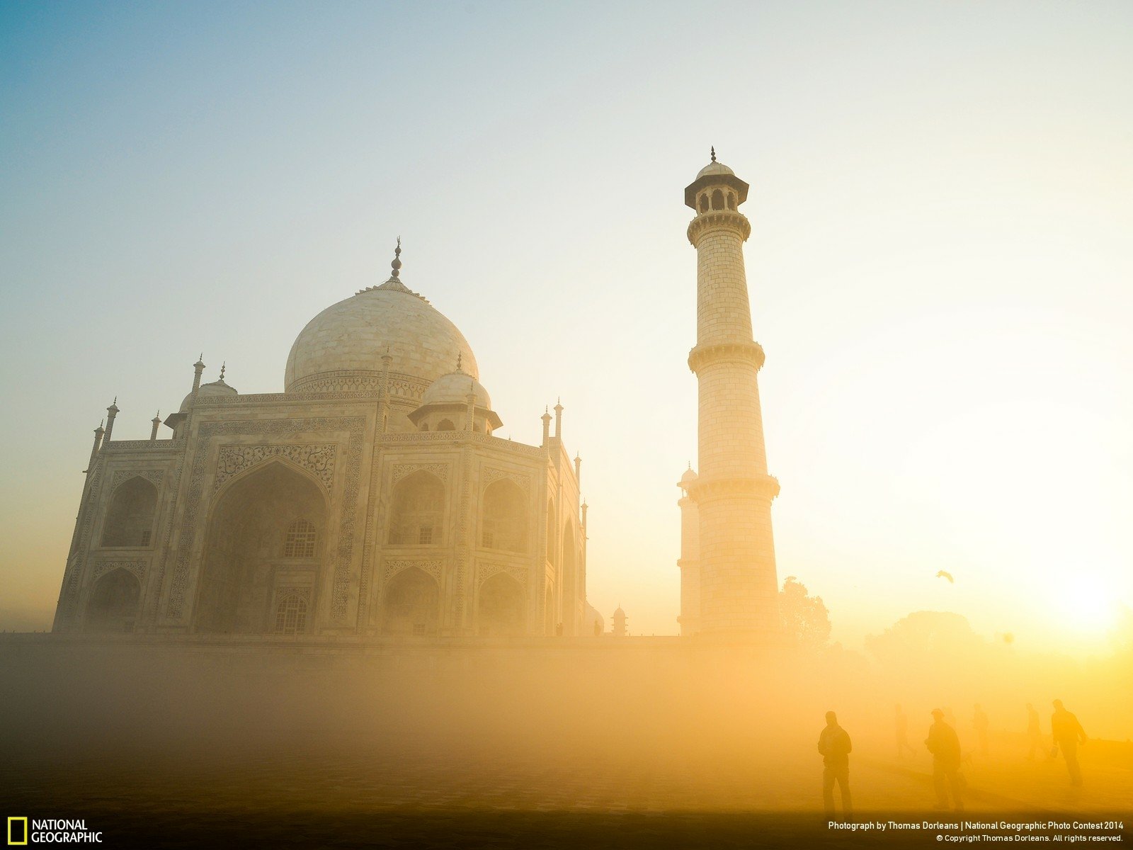 HD desktop wallpaper of the Taj Mahal monument in India, showcasing its iconic dome and minaret bathed in soft morning light and mist.