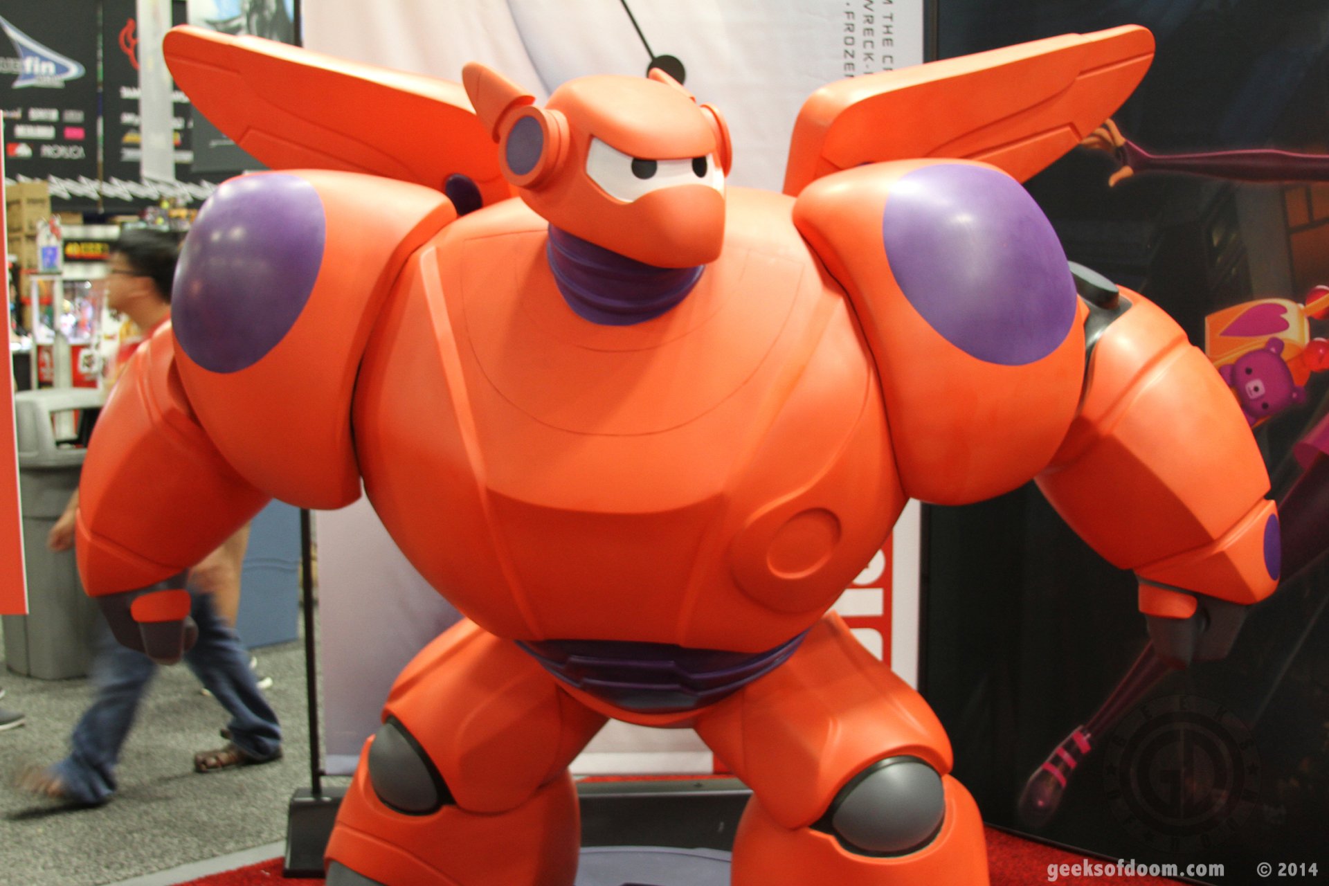 HD desktop wallpaper featuring Baymax from Big Hero 6 in an armored suit, posing for fans.