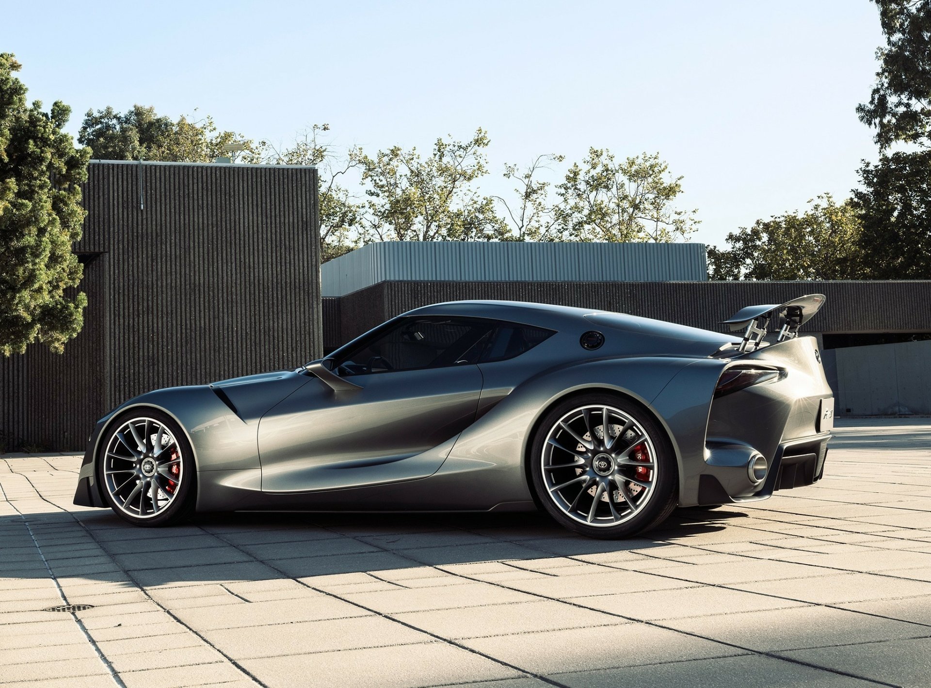 Silver Toyota FT-1 concept supercar showcased outdoors in HD, highlighting its sleek design and aggressive stance as a futuristic vehicle and desktop wallpaper.