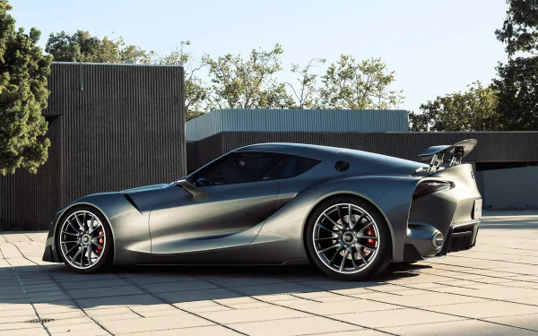 Silver Toyota FT-1 concept supercar showcased outdoors in HD, highlighting its sleek design and aggressive stance as a futuristic vehicle and desktop wallpaper.