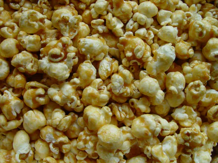 Caramel-coated popcorn dessert, golden sweet clusters filling the frame — 2K Quad HD PC desktop wallpaper and background.